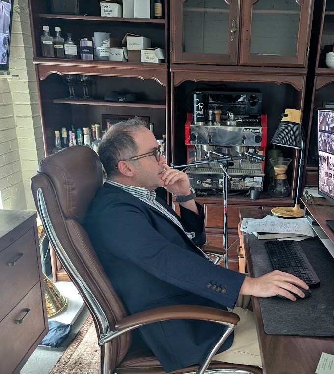 Kevin Pedeaux at his desk monitoring camera feeds across vendor operations.